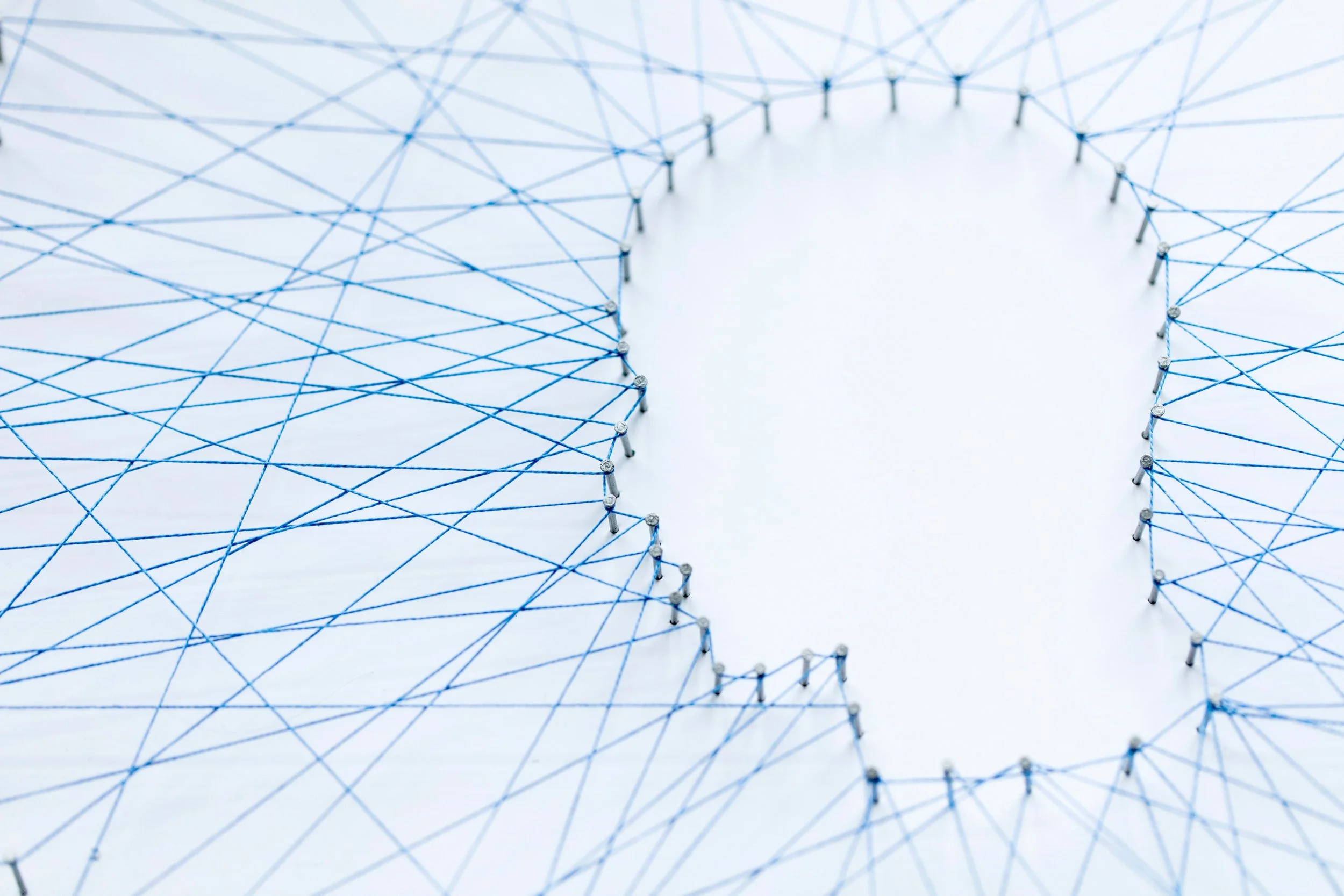 Web of string creating the outline of a silhouette of a head