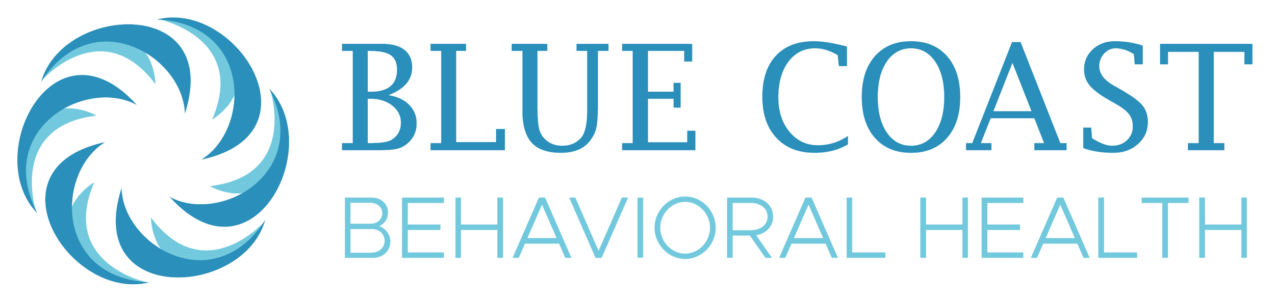 Person smiling with curly hair and glasses, wearing a striped shirt and pendant necklace.