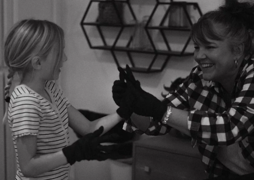 sibling attending birth of her sister, putting on gloves