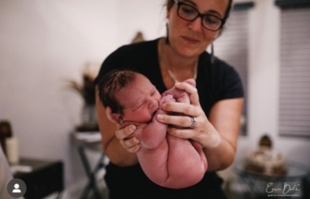 midwife bri doing newborn exam
