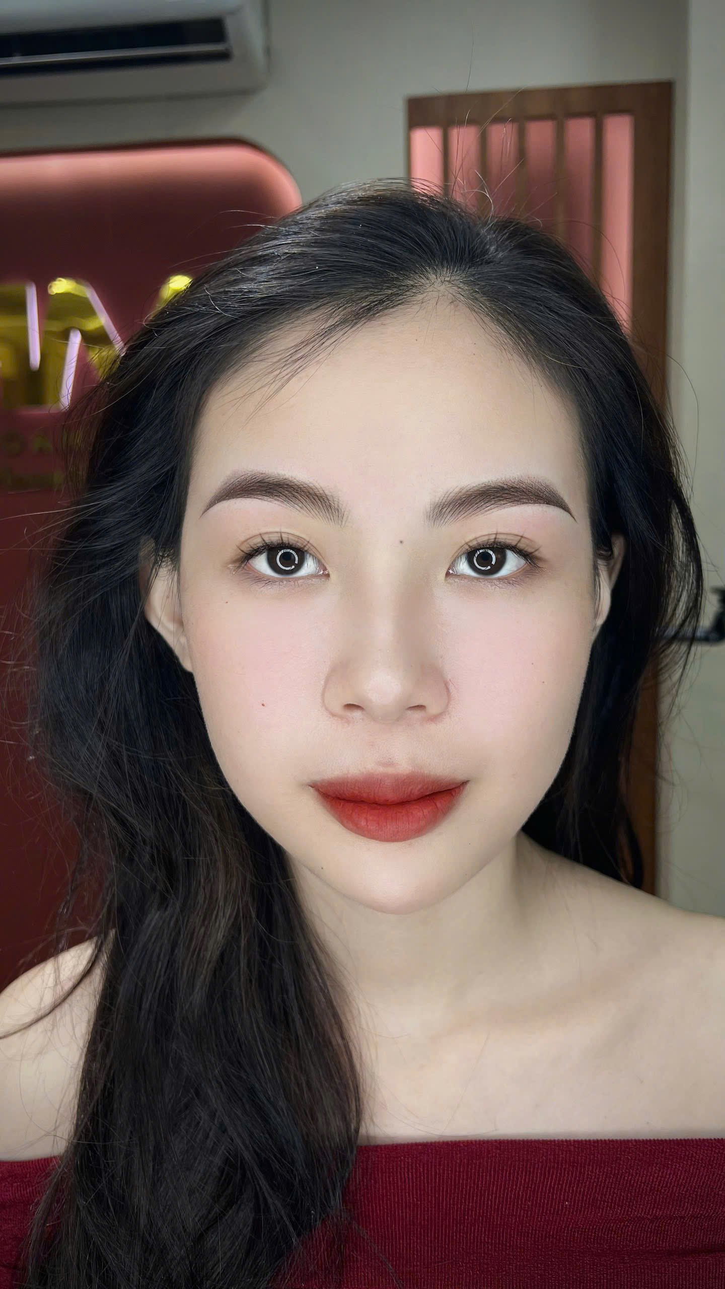 Portrait of a woman with makeup in a red top
