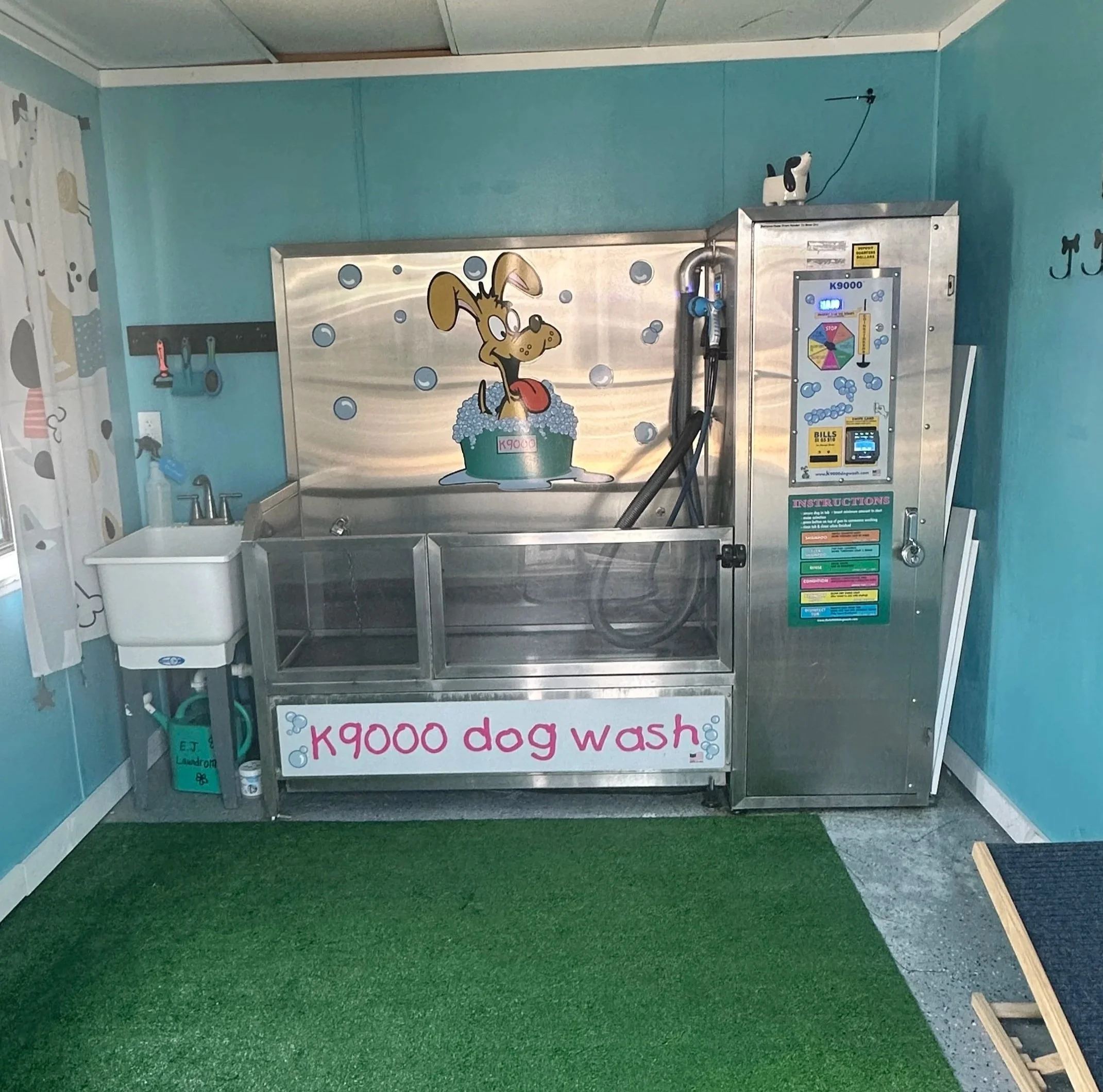 Self-service dog wash station with a colorful design and instructions for use. Features a cartoon dog, wash tub, and payment options.