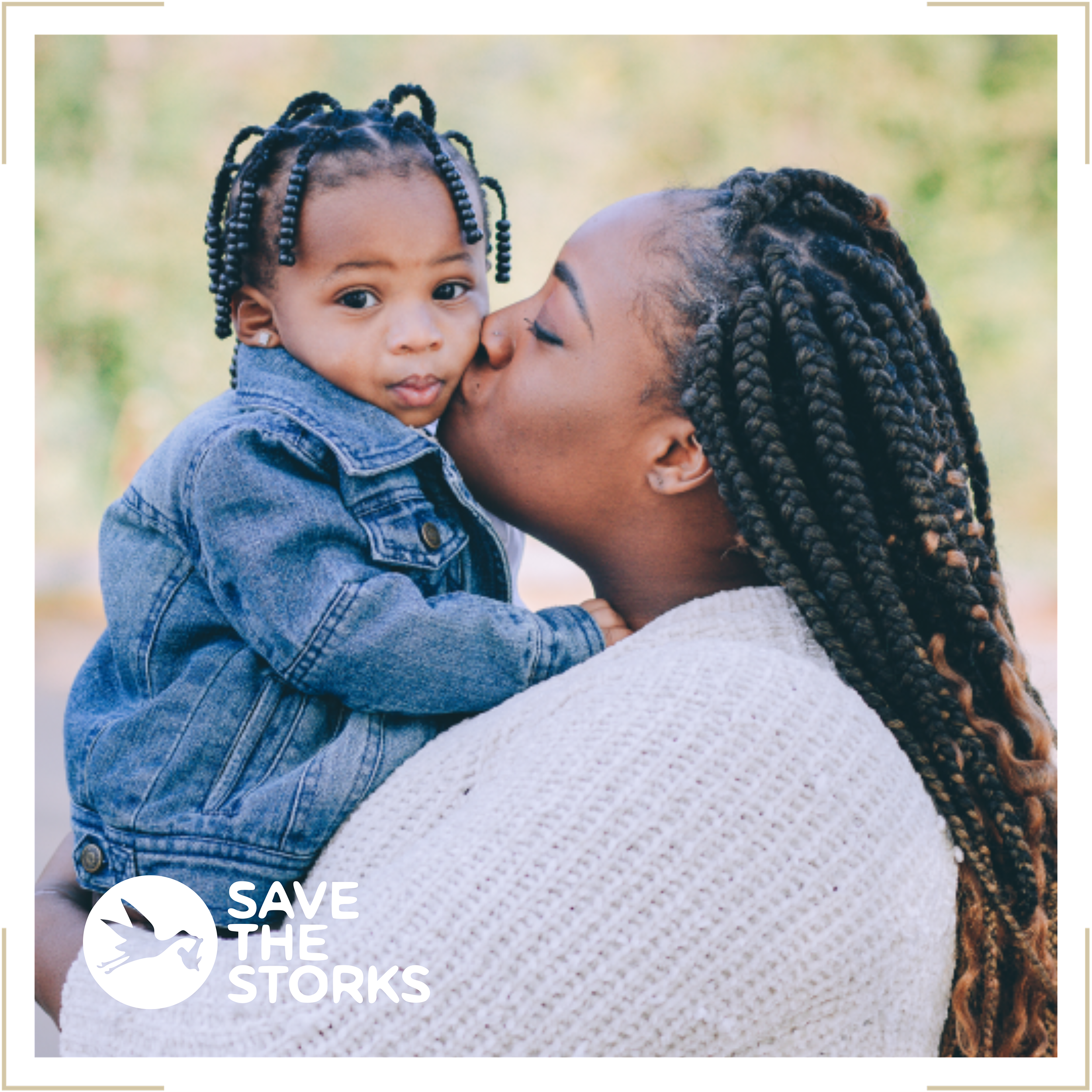 A woman with braided hair kissing a young girl with braided hair on the cheek. The girl is wearing a denim jacket and looking at the camera. There is a logo in the bottom left corner that says 'Save the Storks'.
