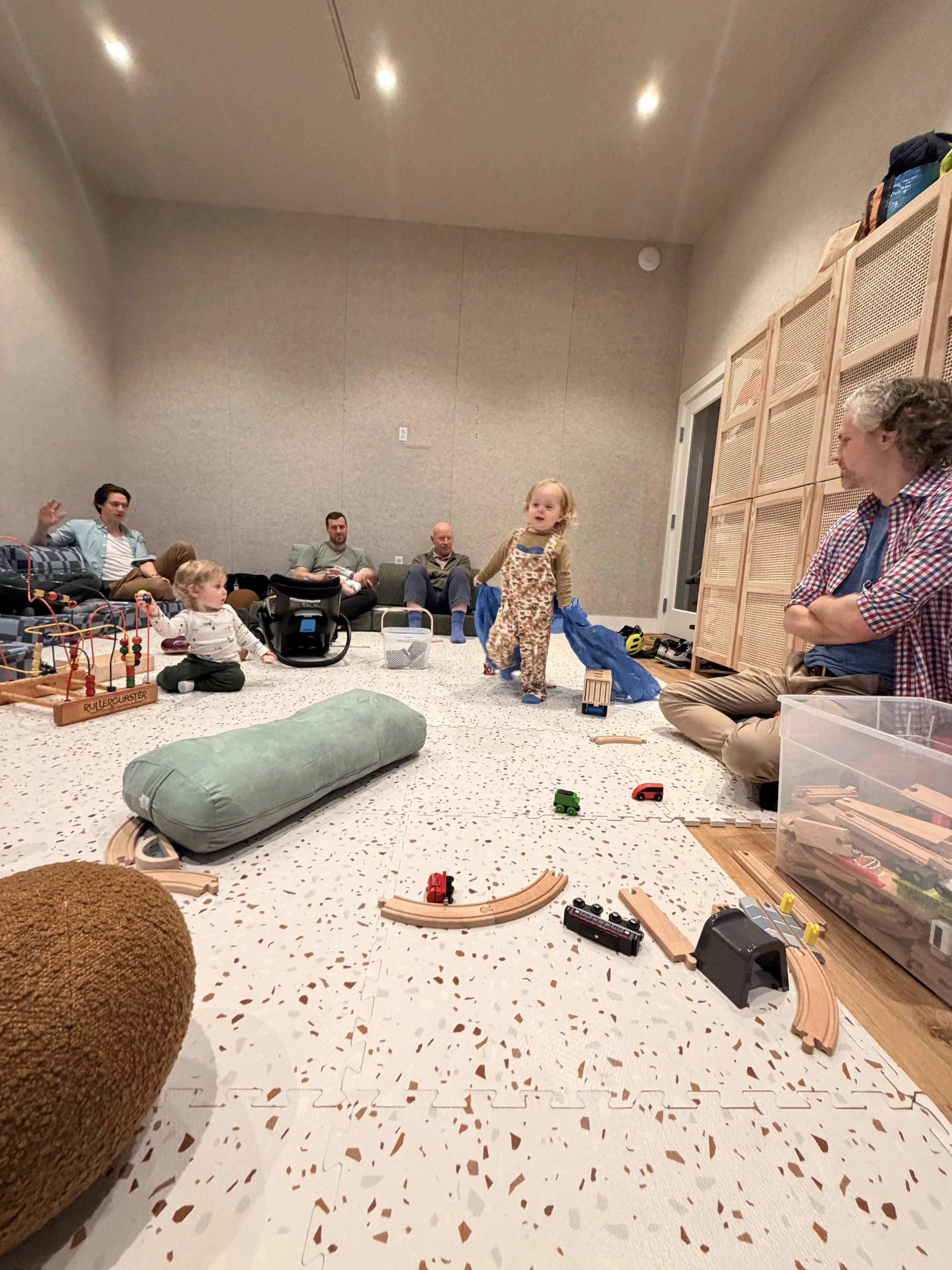 New dads and their babies and toddlers playing and talking during a New Dads Group at Outer Village.