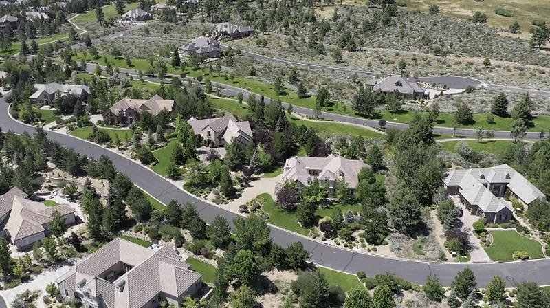 Montreux Aerial view of a suburban neighborhood with houses, roads, and green trees.