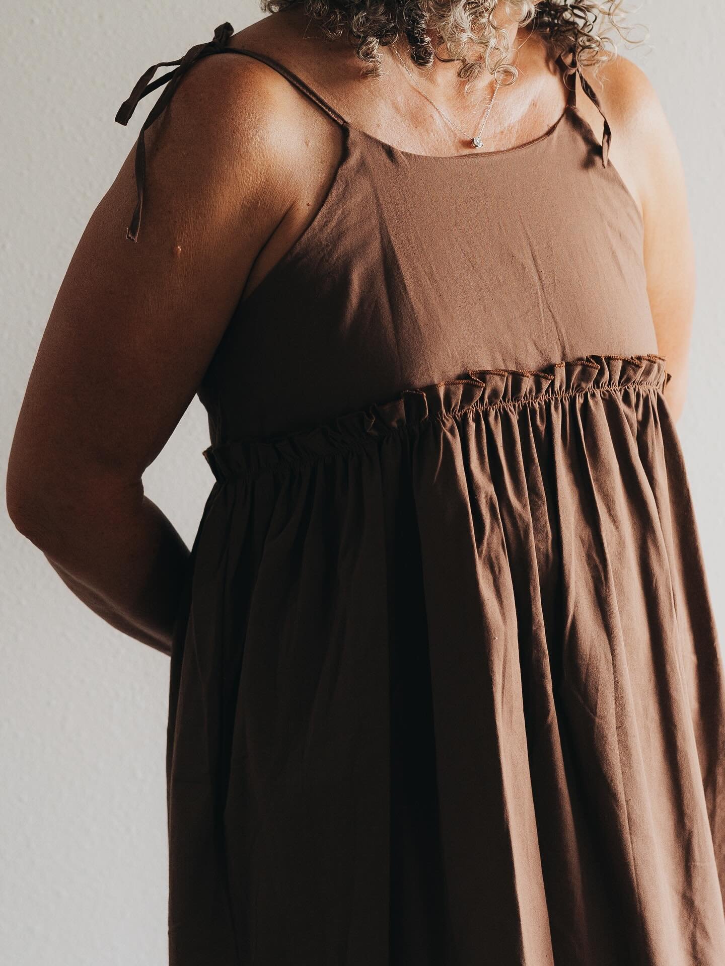 This sassy piece is all in the girly details! Our favorite aspects are the adjustable tie straps, ruffle waist, and light &amp; airy fabric.