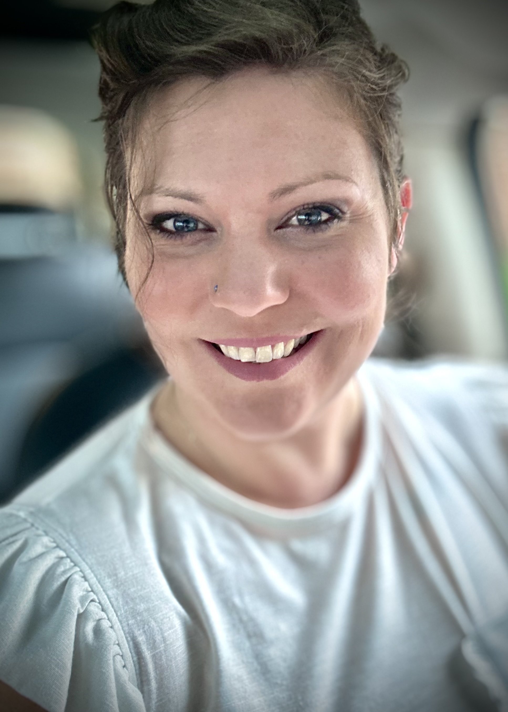 women sitting, white shirt, smile
