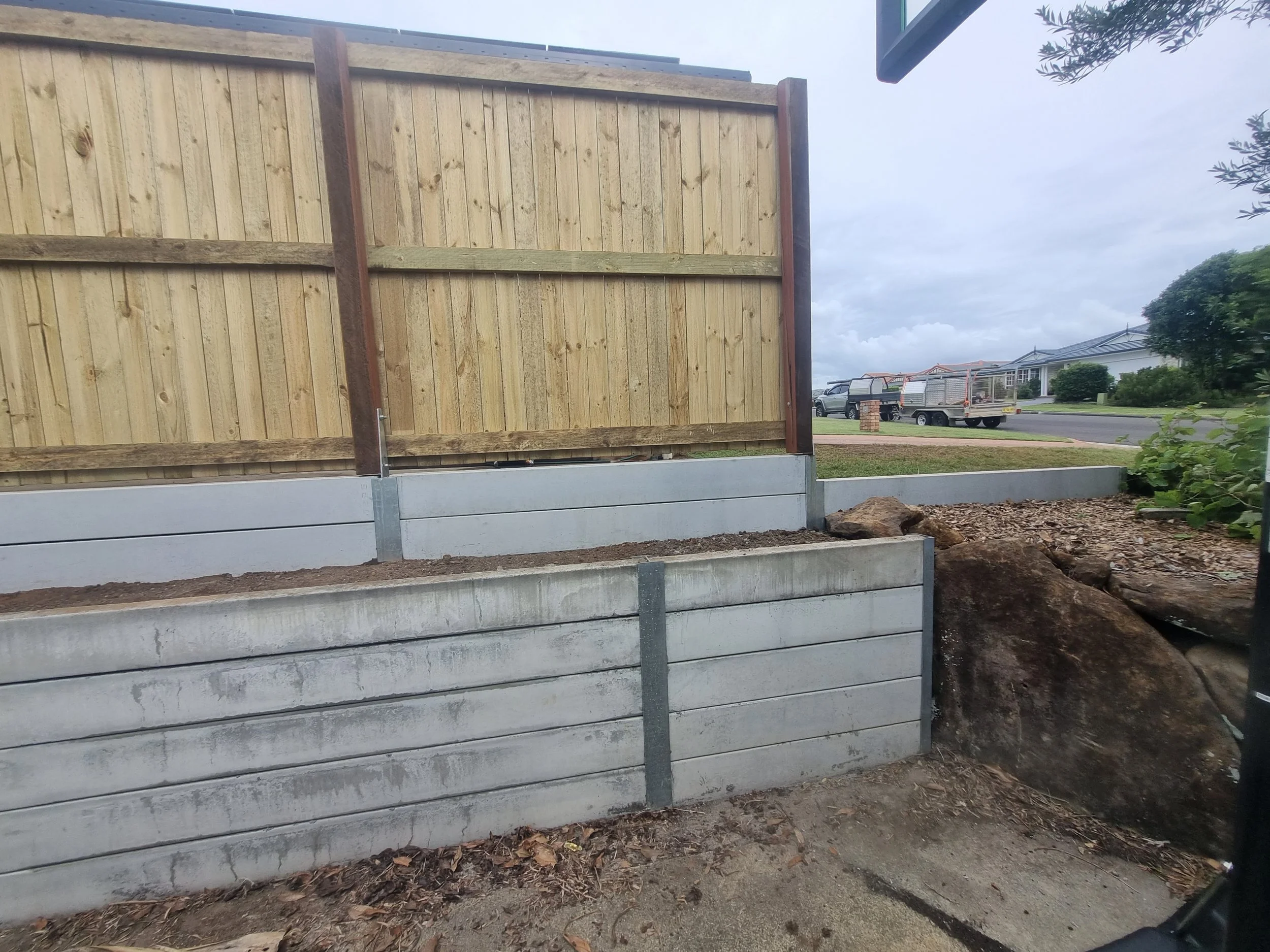 East Ballina Treated Pine Fence, mounted on a Concrete Sleeper Retaining Wall. This Fence has Hardwood Posts. East Ballina Landscaper.