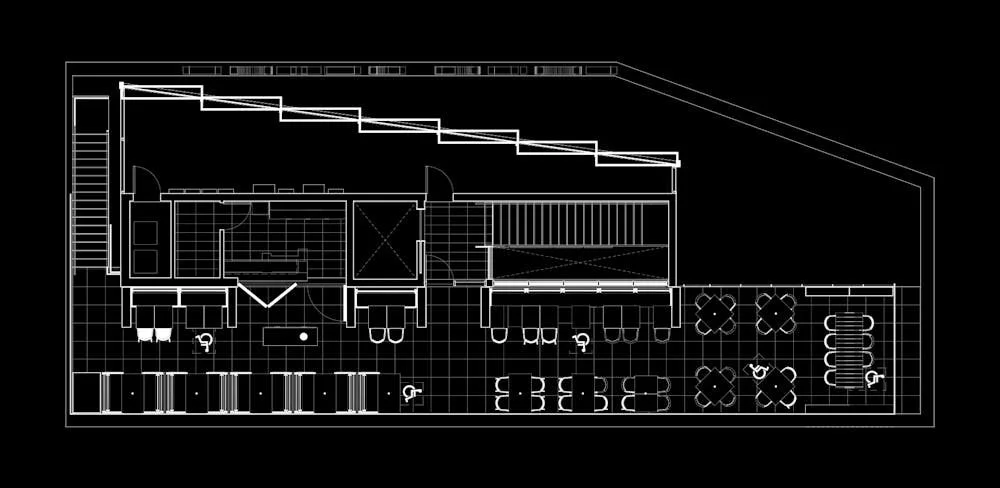 Architectural floor plan of a restaurant layout with seating, kitchen, and counters.