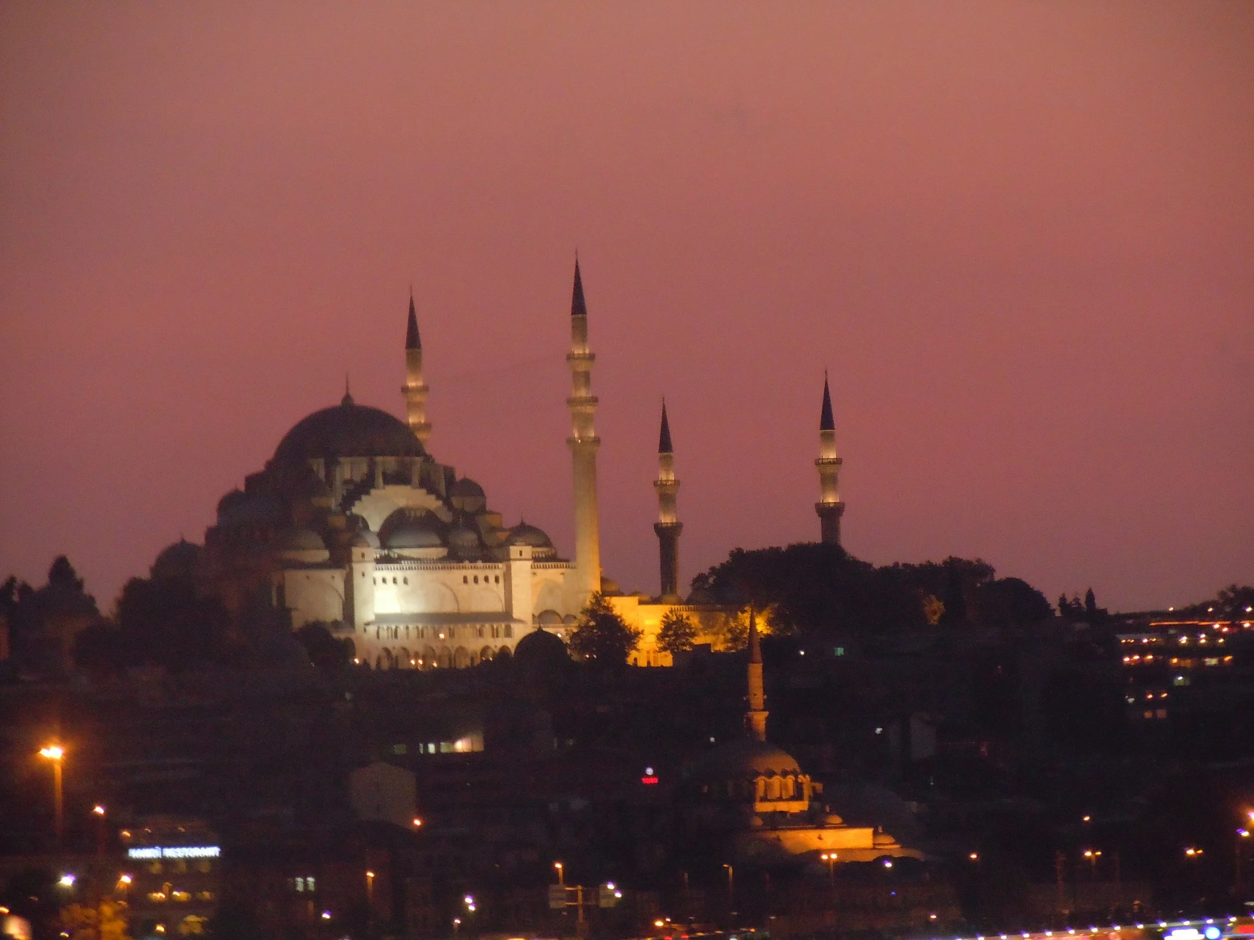 Silhouette of a mosque with minarets at sunset in Istanbul.