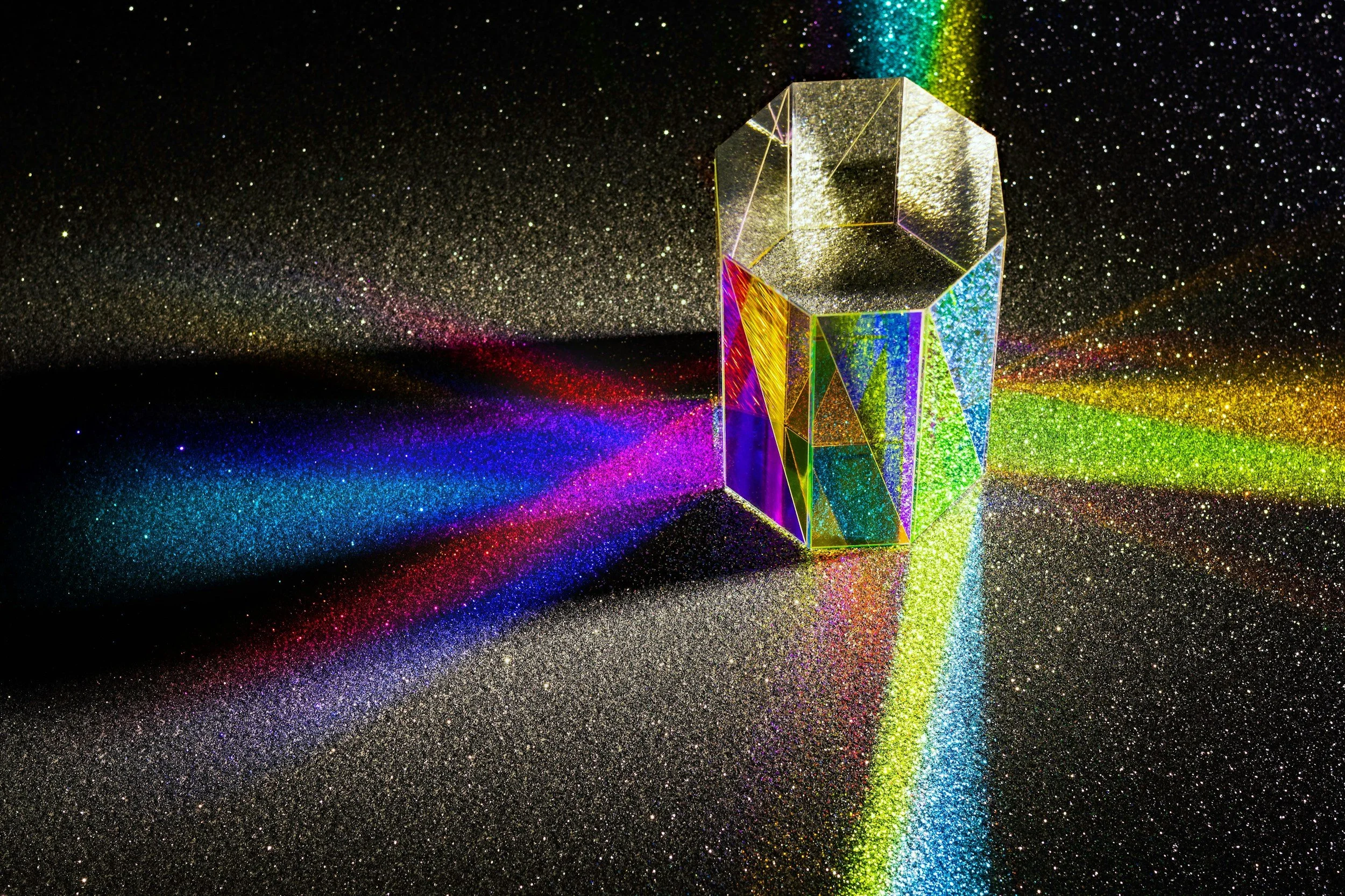 Prism through octagonal shape with speckled black background