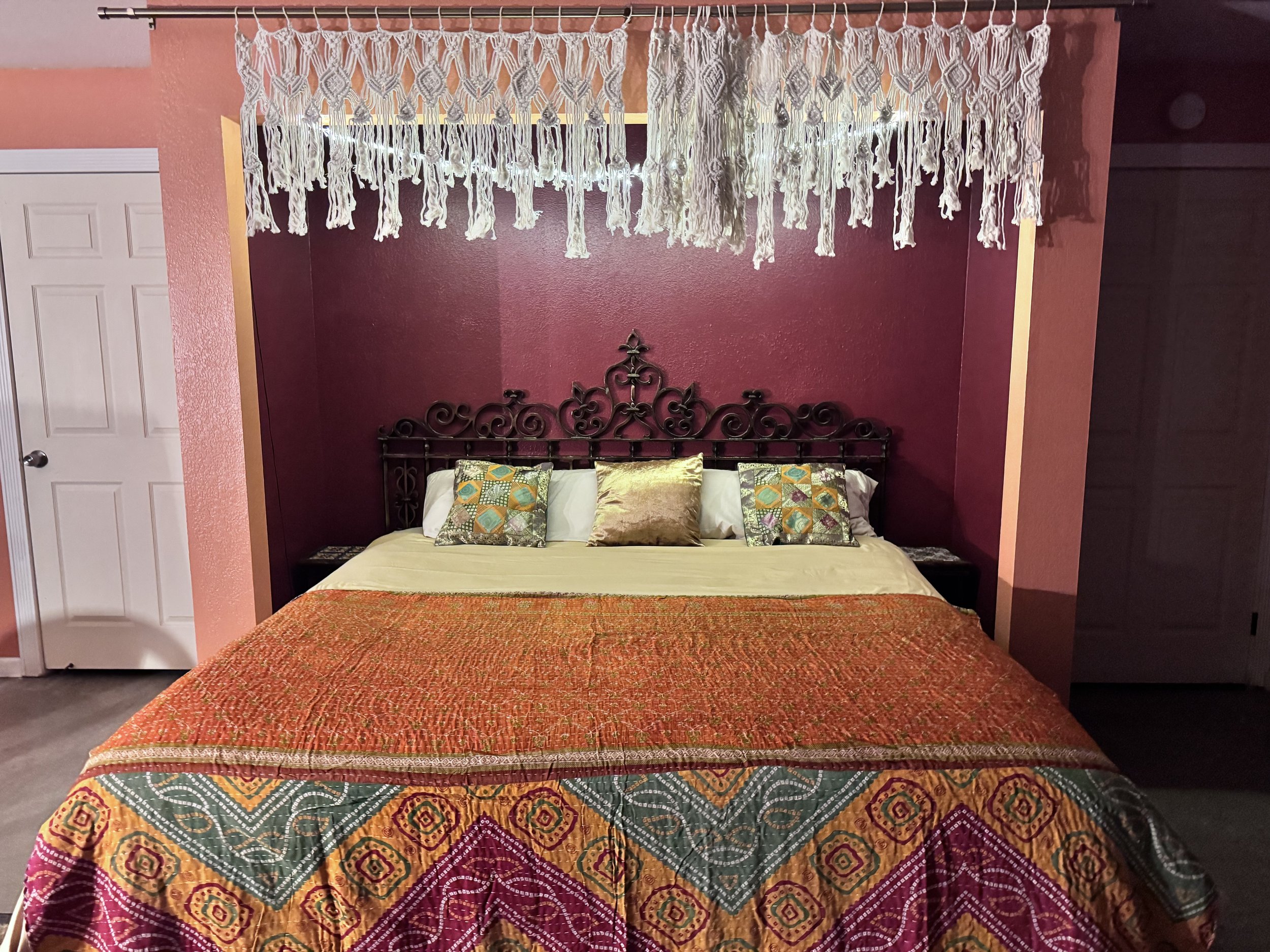 The Chambers is a large open room with warm colors, vibrant decor and a king size bed. The Chambers also has its own bath and attached kitchenette.