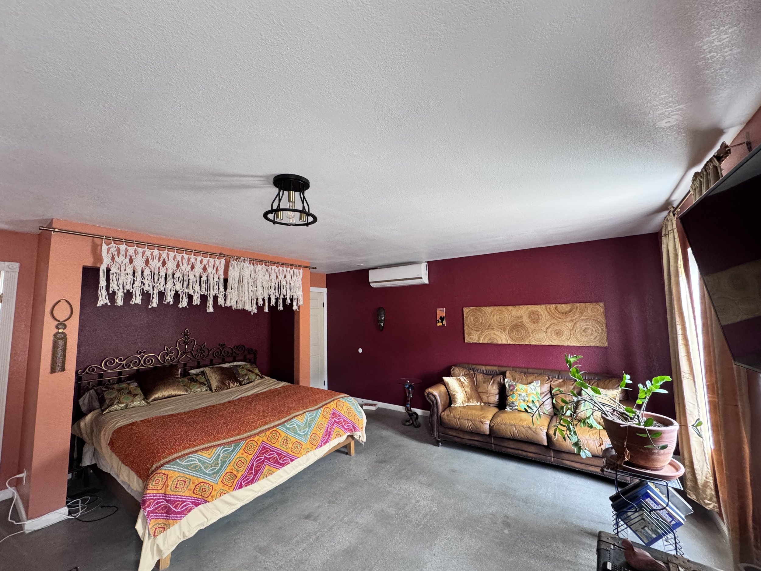 The Chambers includes a vintage leather couch with fluffy throw pillows. The Chambers also has its own bath and attached kitchenette.