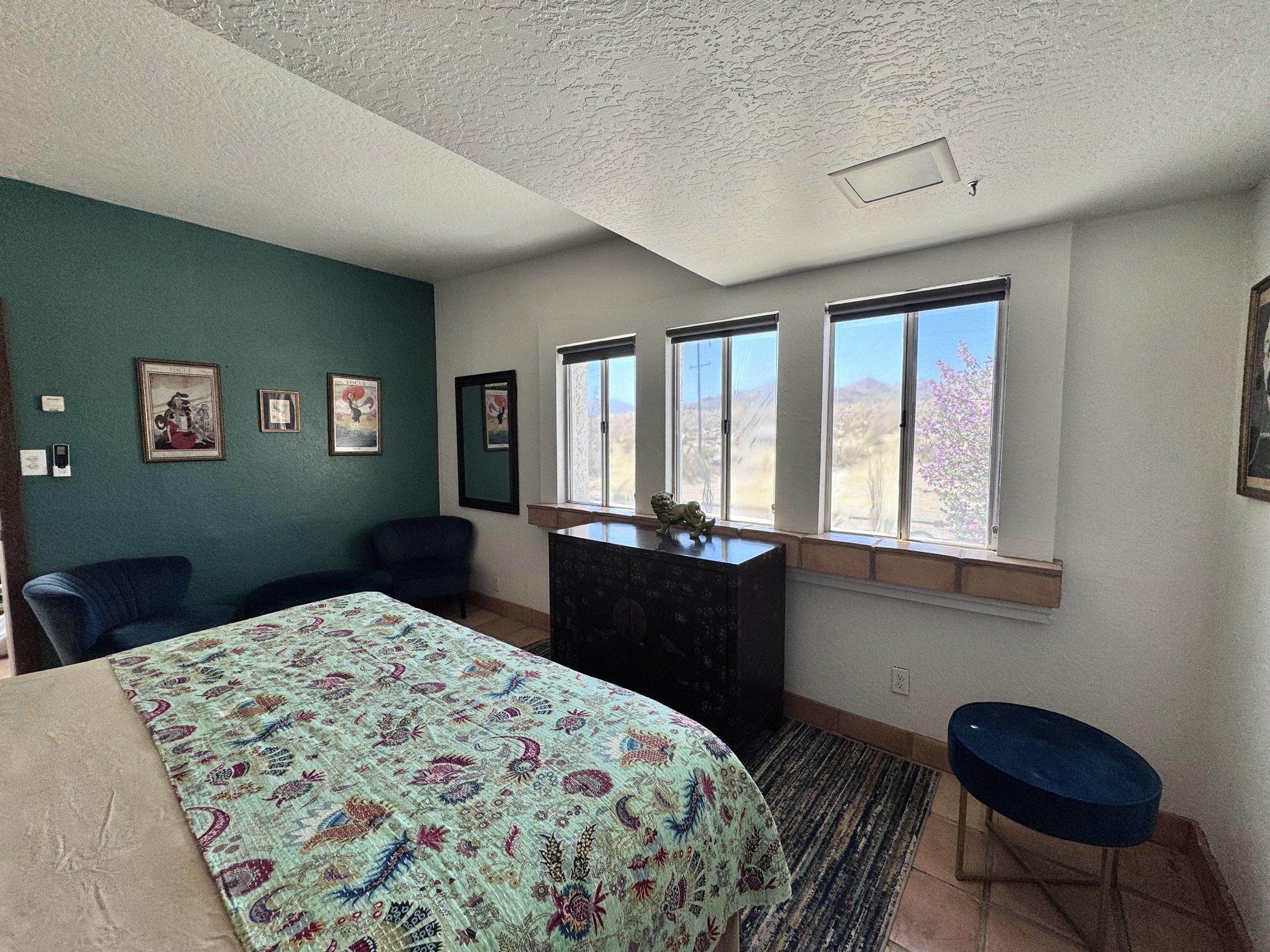 The Vogue Room with king size bed, clothing storage and separate seating area.