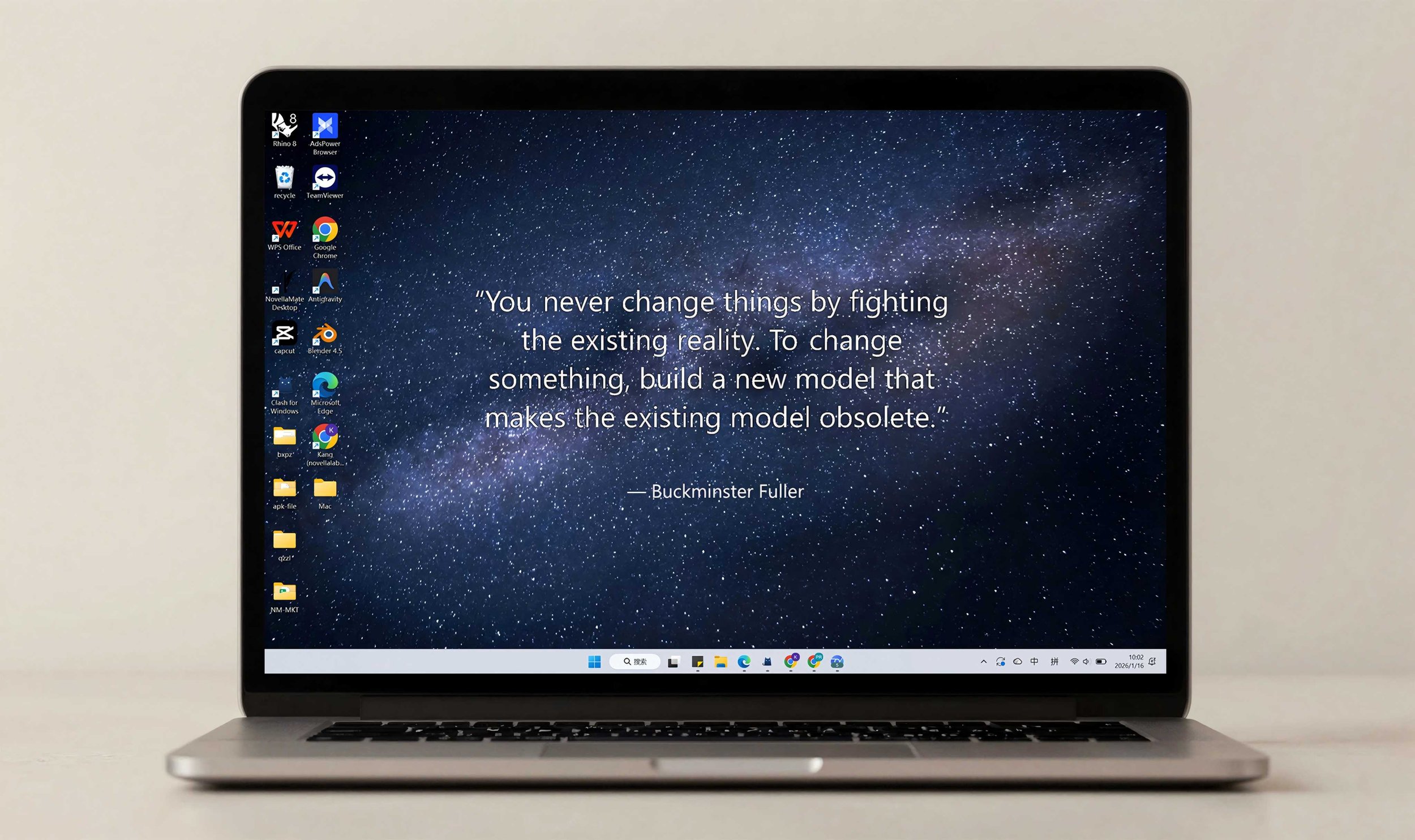 The Desktop Edition of the literary clock. Open laptop with a desktop background showing a starry night sky and a quote by Buckminster Fuller