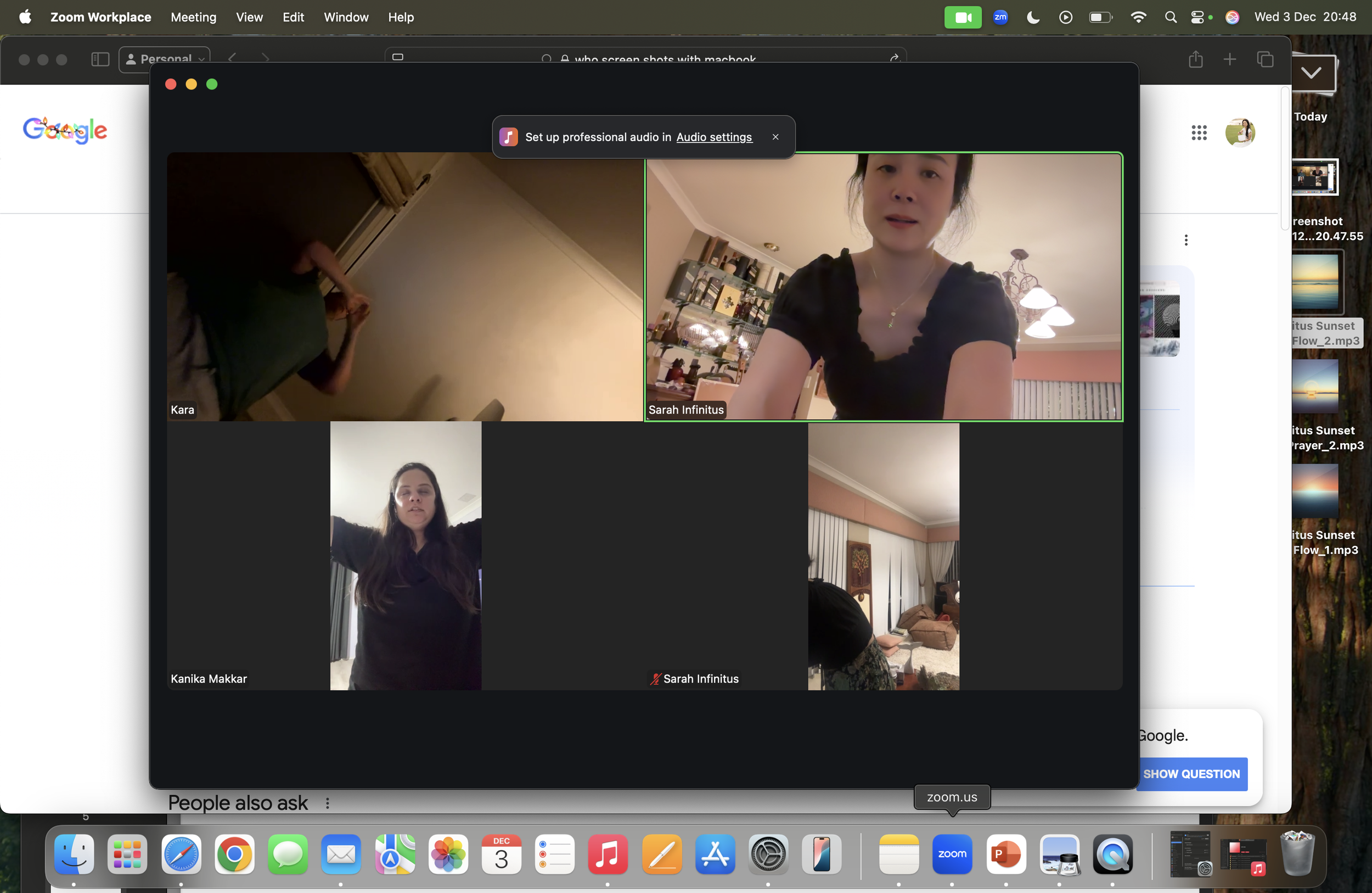 Screenshot of a Zoom video call with four participants, showing their faces. The background shows a room with shelves and lighting fixtures. The interface displays multiple windows and icons on the desktop.