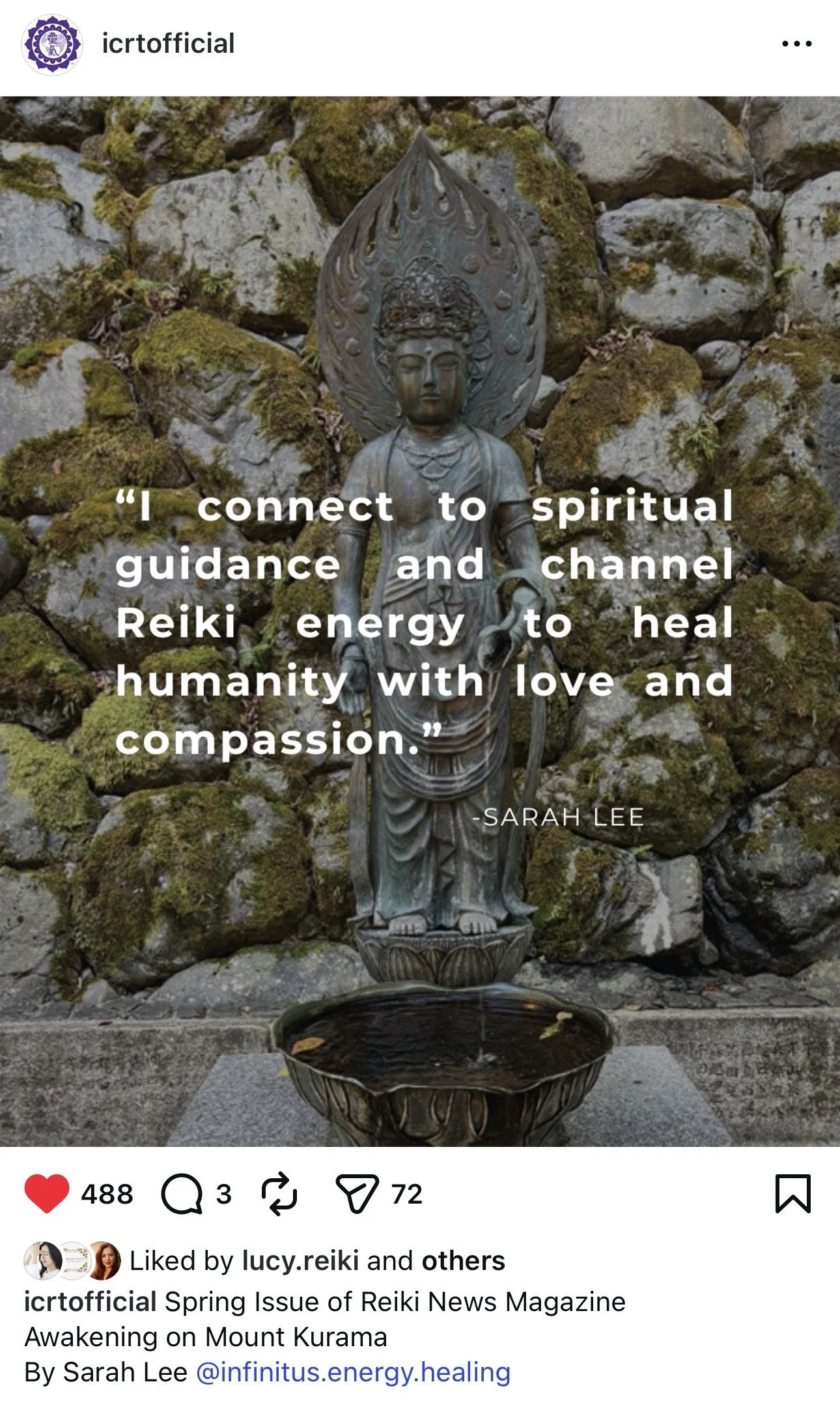 A metal statue of a spiritual figure with a large halo-like design behind its head, standing on a stone base in front of a moss-covered stone wall. The statue appears to be pouring water from its hands into a bowl below.