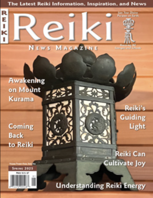 The cover of Reiki News Magazine, Spring 2023 issue, featuring a decorative lantern with a wooden top resembling a crown of rounded stones on a wooden surface.