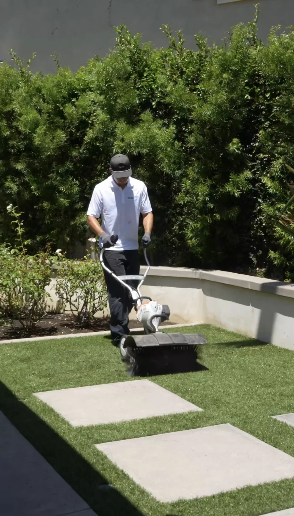 SafeStep crew professionally cleaning artificial turf on a North County job