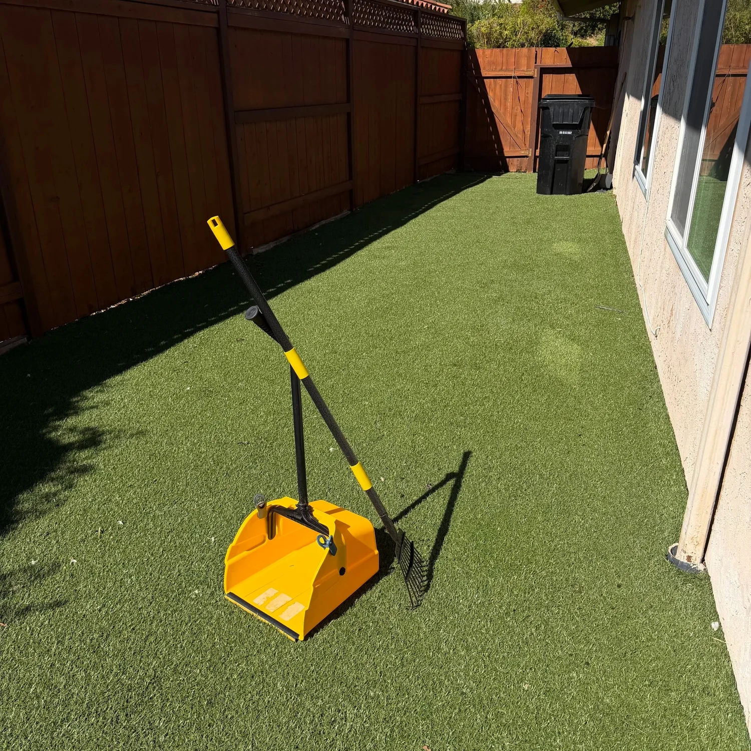 SafeStep pet waste removal scooper used for professional dog poop scooping in a North County San Diego backyard