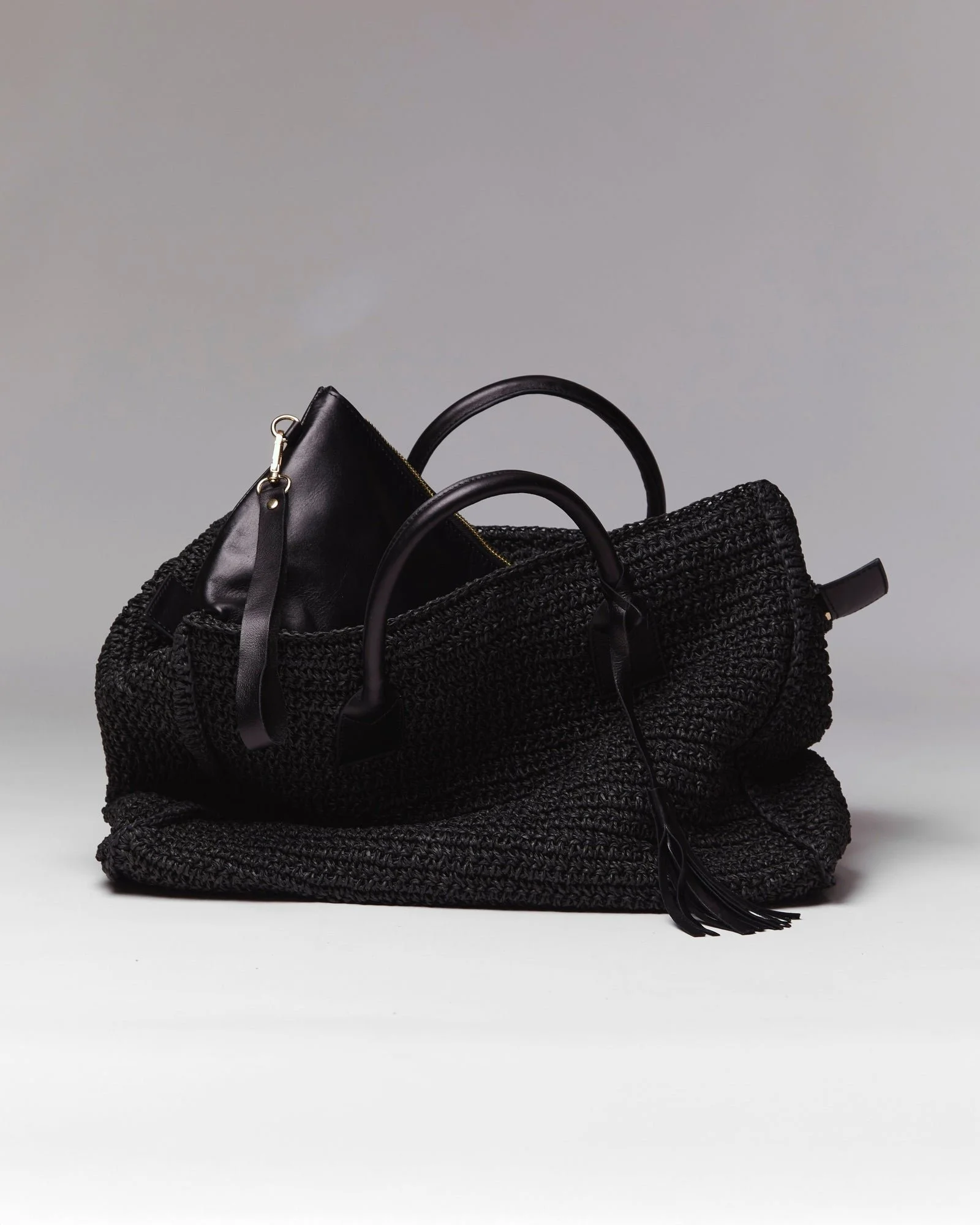 Noam Hazan crocheted raffia travel bag with black calfskin trim
