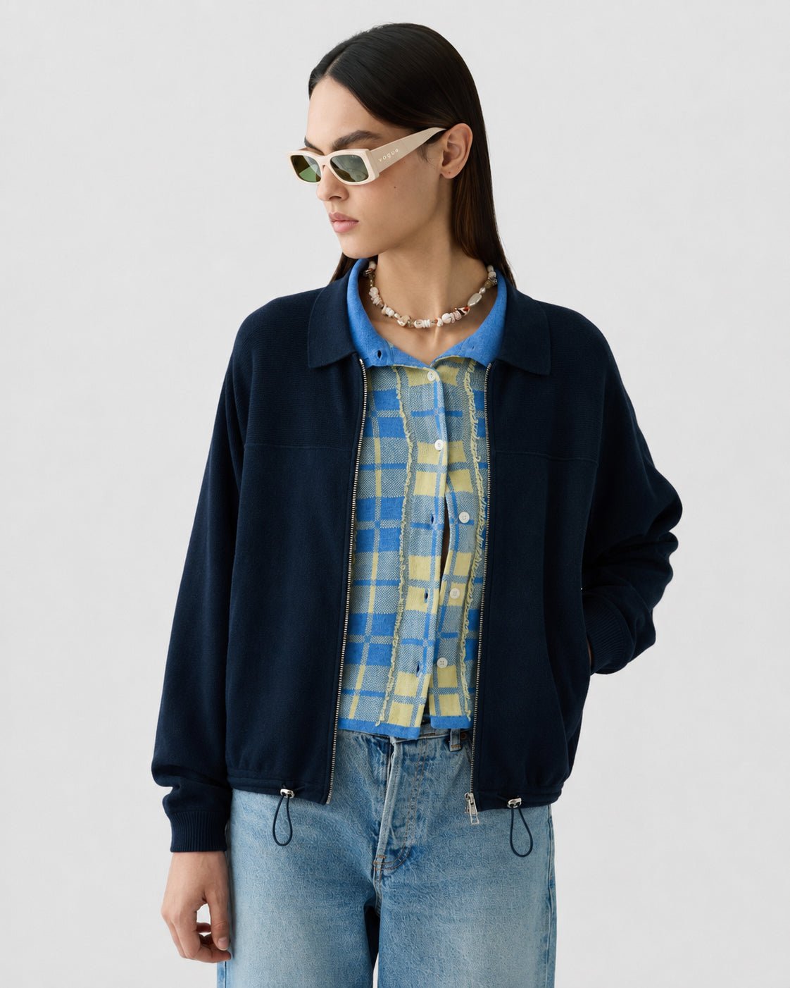 Model in Guest in Residence silk-linen plaid mini skirt with fringed hem