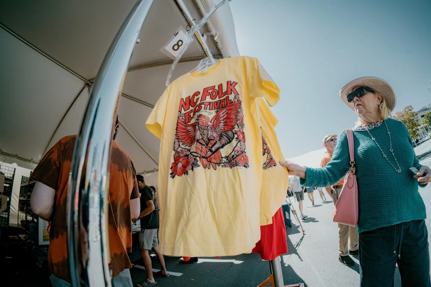 We've got racks on racks on racks....of merch still available! You can buy your NC Folk Fest gear online! Perhaps it would make a nifty gifty this holiday season? 🎁