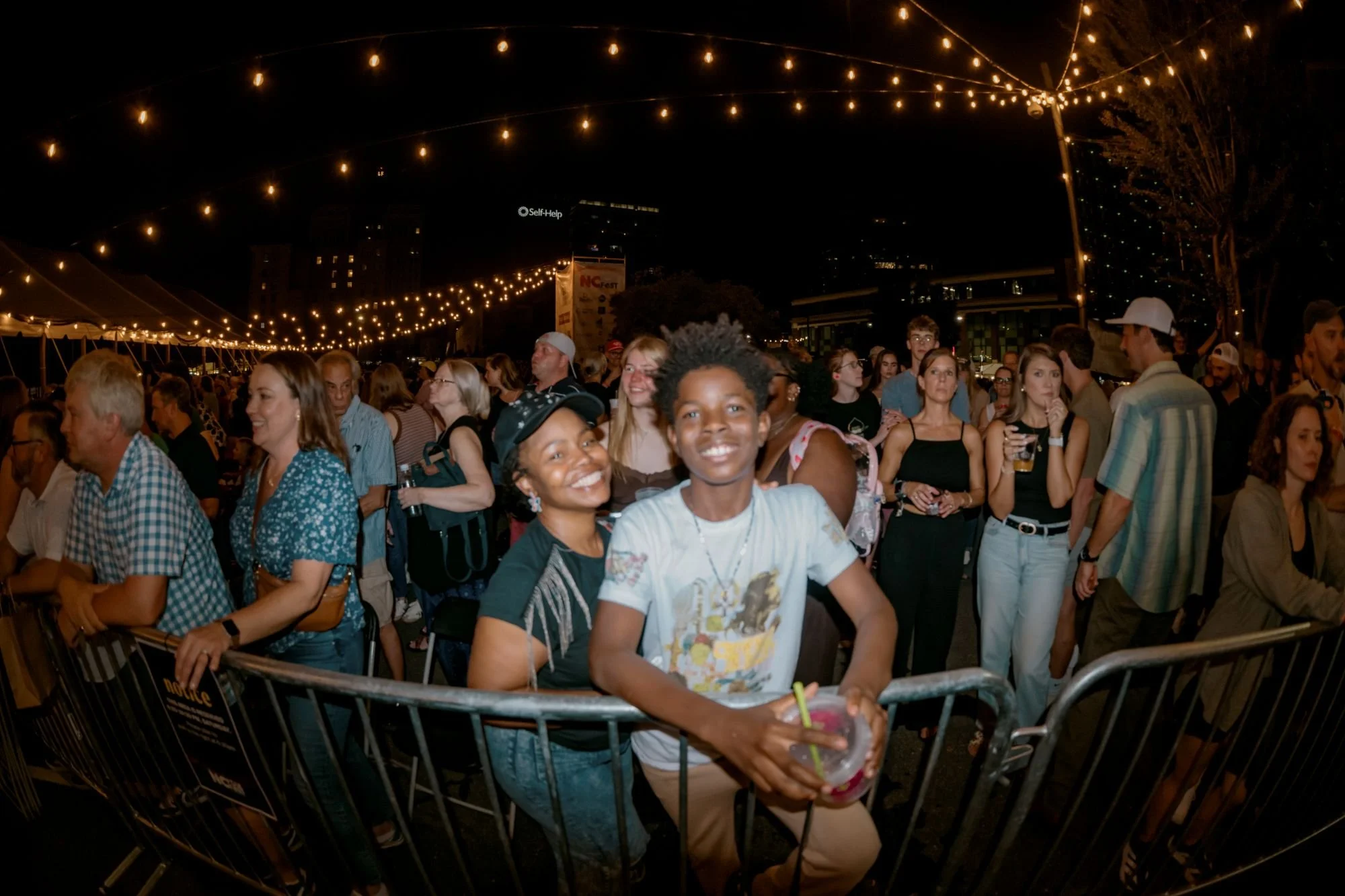 A large crowd of people enjoying the 2026 Folk Festival in NC.