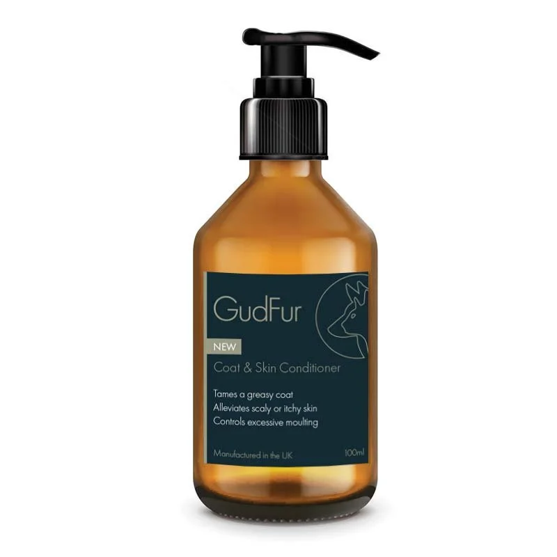Amber plastic bottle with black pump dispenser labeled GudFur Coat and Skin Conditioner for dogs, with text about its benefits.