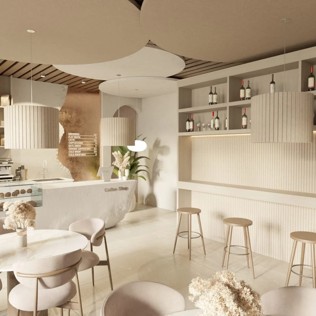 Minimalistički enterijer kafića sa belim pultom, visećim lampama, drvenim barskim stolicama i policama sa vinom, cvećem i zelenilom. Akustični filc paneli su diskretno uklopljeni za prijatniju atmosferu.