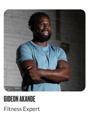 A man wearing a blue shirt with arms crossed, smiling, standing in front of a brick wall. Text below reads: Gideon Akande, Fitness Expert.