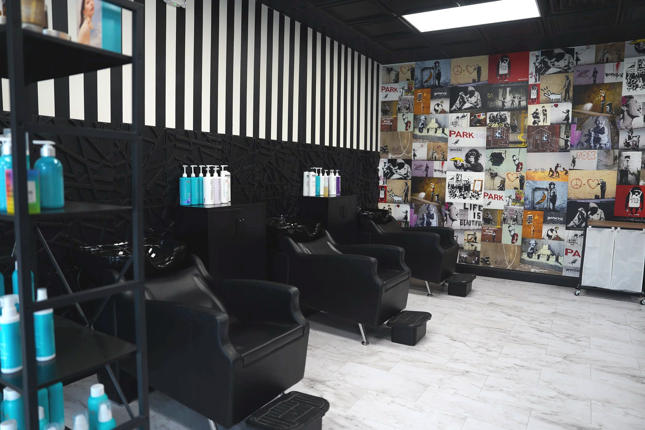 Black and White Shampoo chairs with Banksy wallpaper