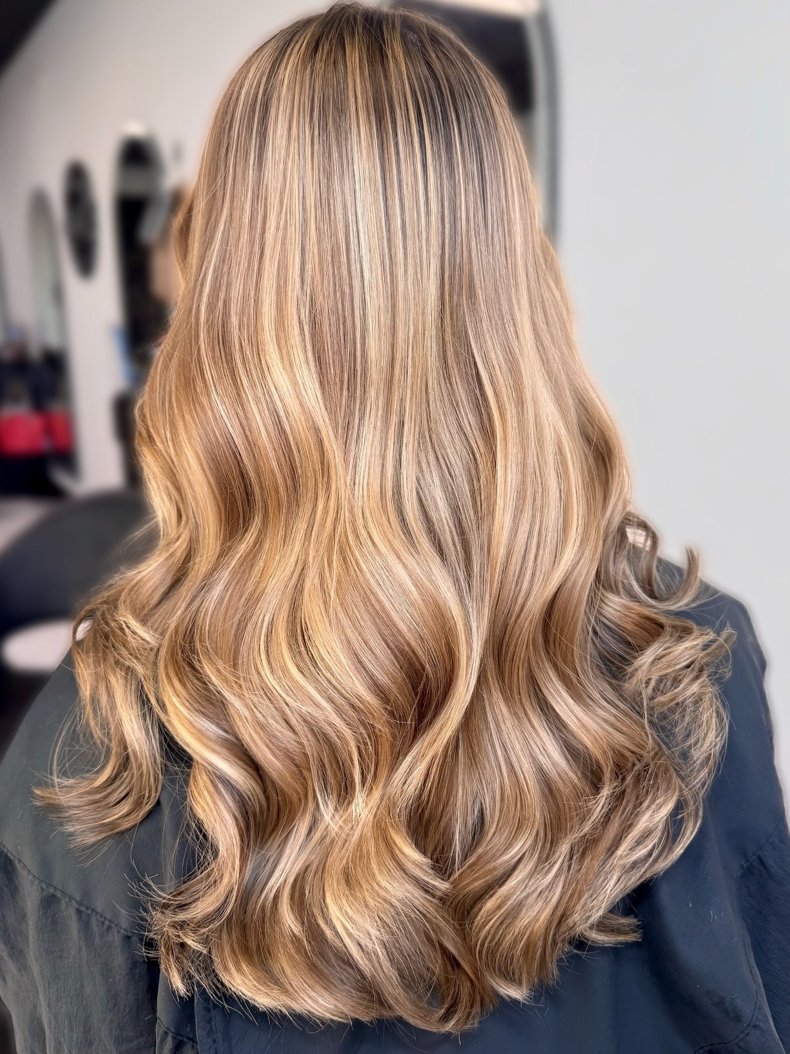 Dimensional brunette with caramel highlights and soft face-framing color at Altair Salon in Palm City, FL. Custom brunette hair color and highlights with blended dimension and a natural finish.