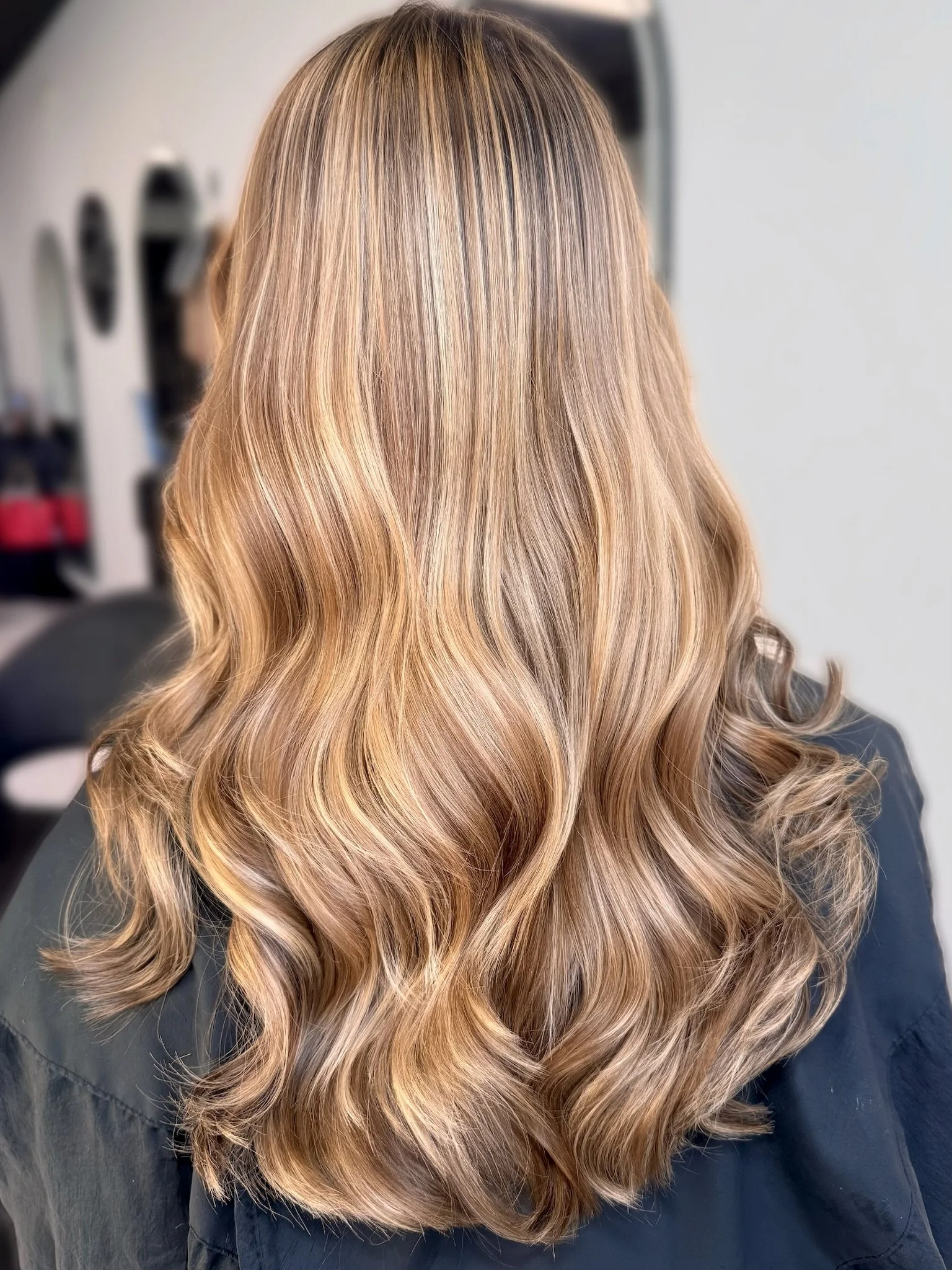 Bright dimensional blonde with seamless highlights and a soft, healthy finish by Altair Salon, serving Jensen Beach, FL. Expert blonding and customized blonde hair color by experienced blonde specialists.