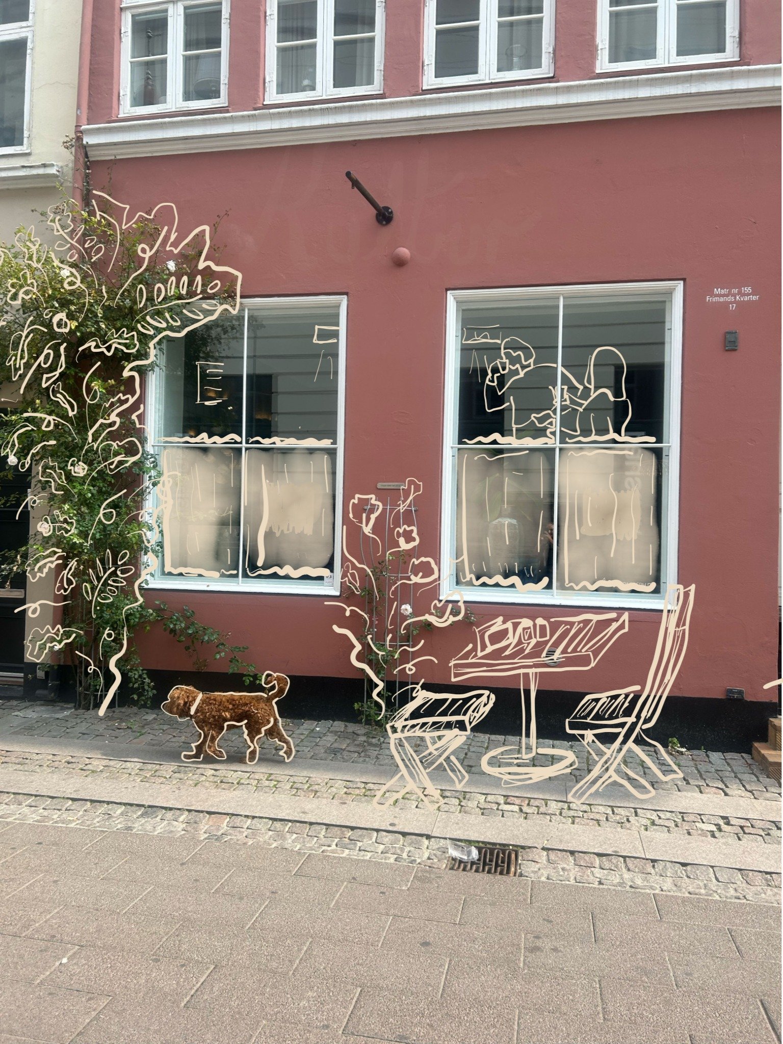 Decorative window art featuring illustrations of a person and a woman sitting at a table, a dog walking on the sidewalk, and plants.