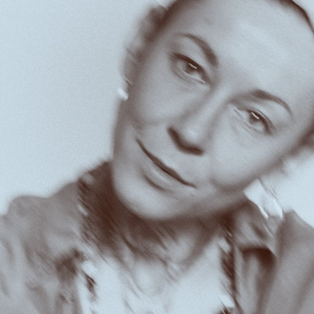 Blurry grayscale portrait of a person smiling
