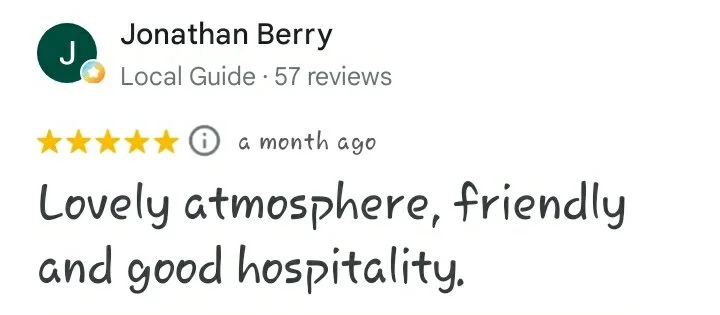 A five star Google review reading "Lovely atmosphere, friendly and good hospitality. – Jonathan Berry"