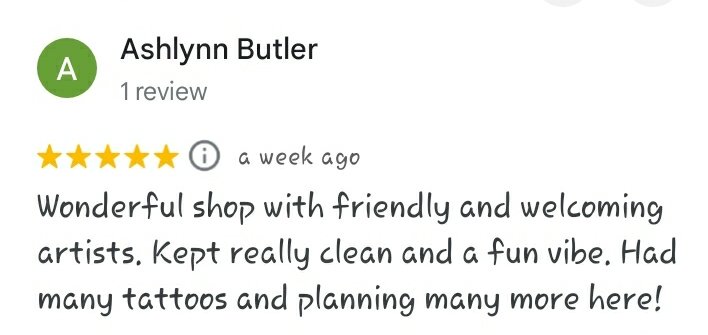 A five star Google review reading "Wonderful shop with friendly and welcoming artists. Kept really clean and a fun vibe. Had many tattoos and planning many more here! -Ashlynn Butler"