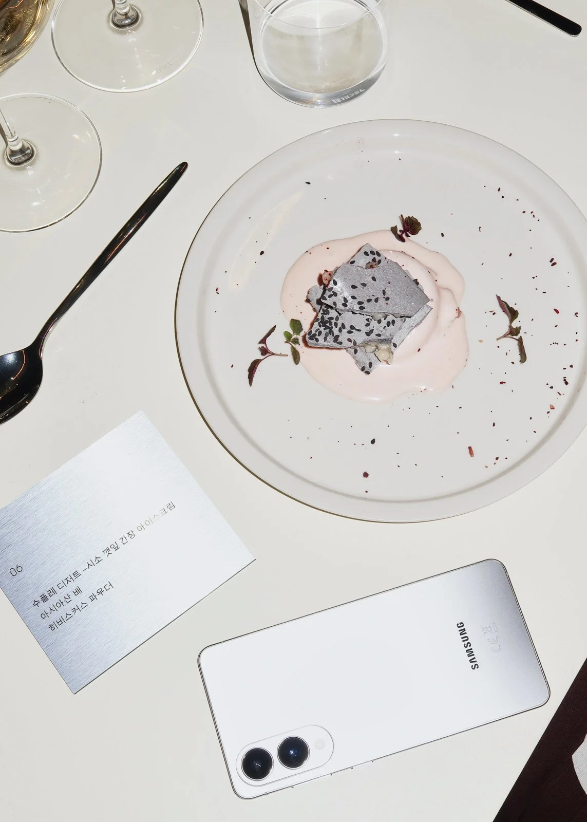 Immersive restaurant build with refined materials and titanium finishes for Samsung brand activation