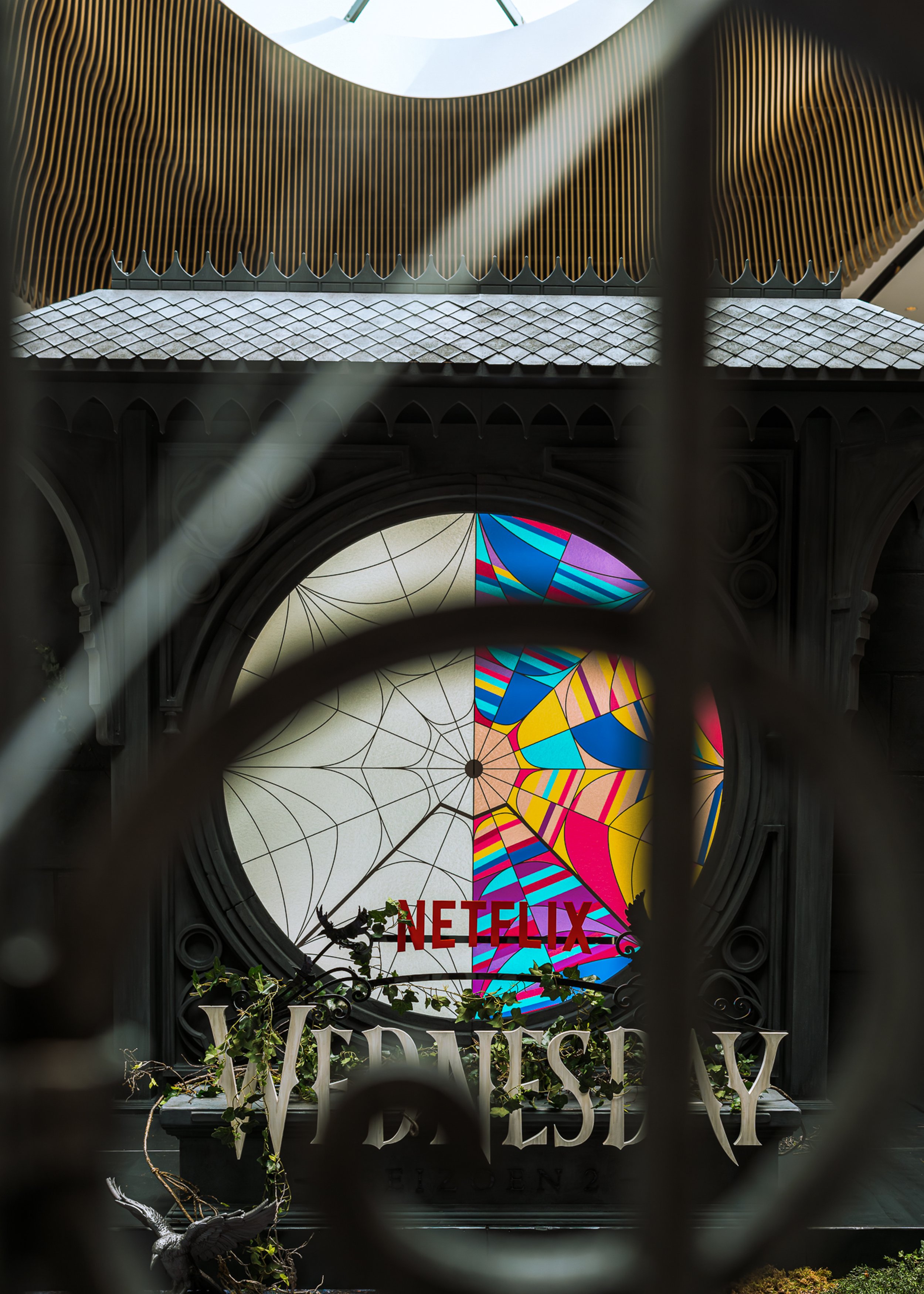 Themed photo booth with spiderweb window inspired by Wednesday series