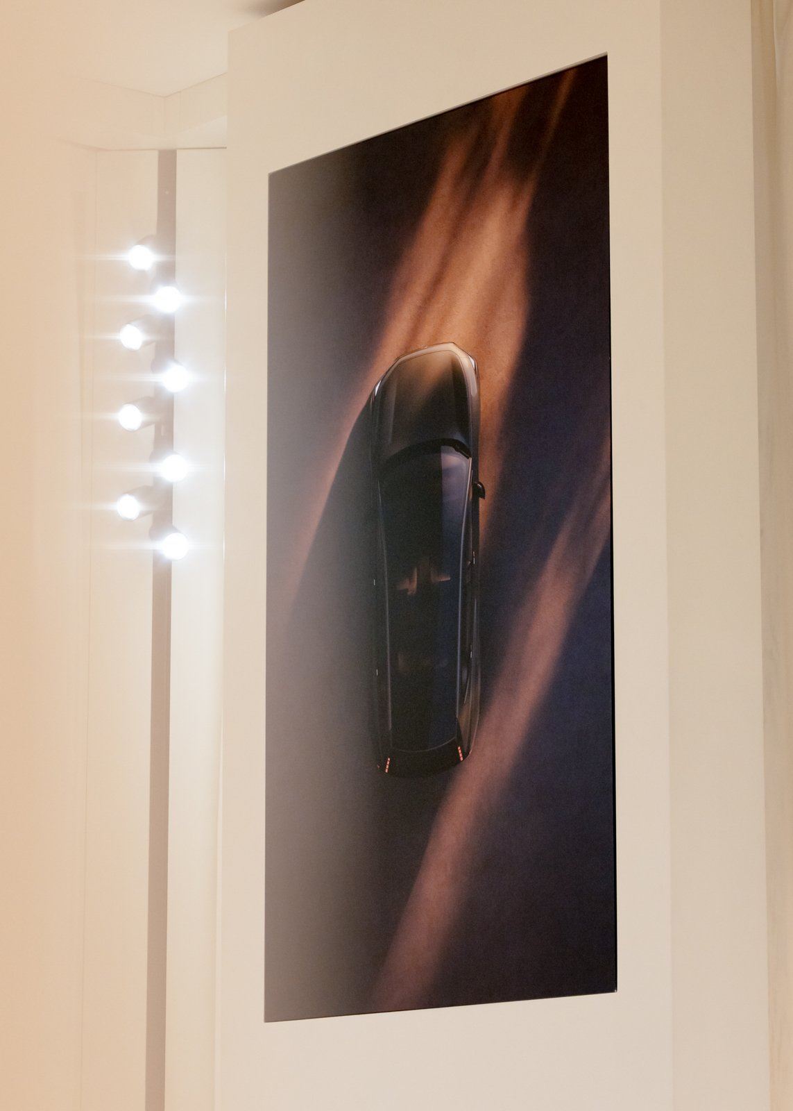 Minimal exhibition booth highlighting car design from all angles