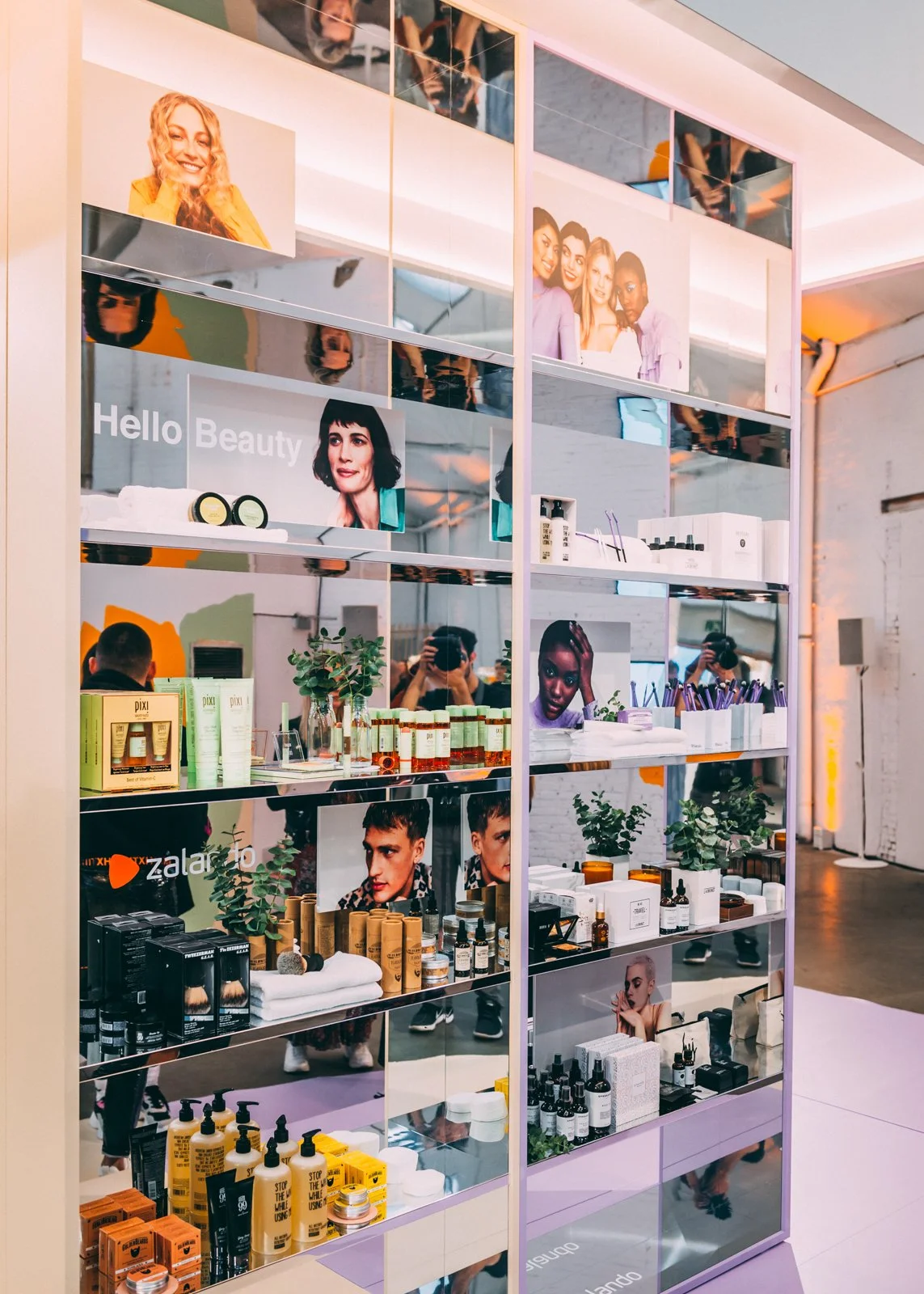 Scalable activation system with central product wall and backstage integration for seamless visitor experience