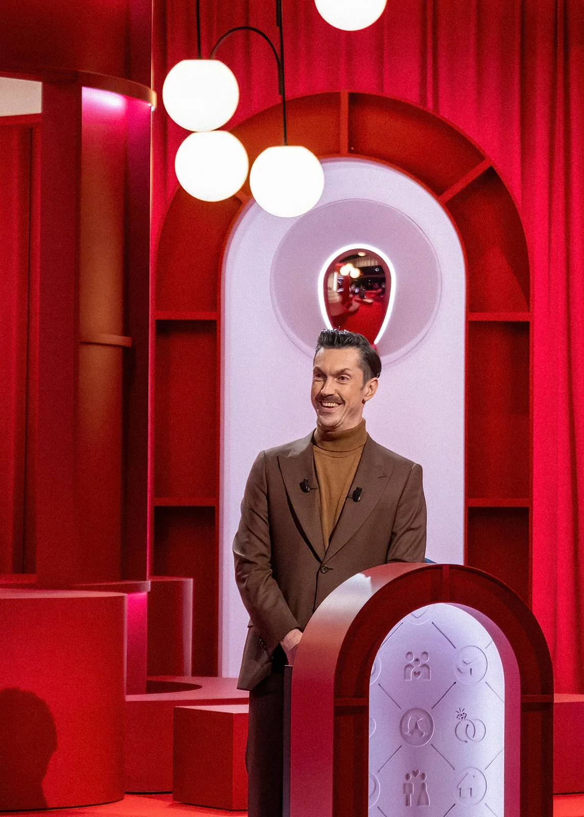 High-end studio environment combining soft textures, lighting design and audience integration for television production