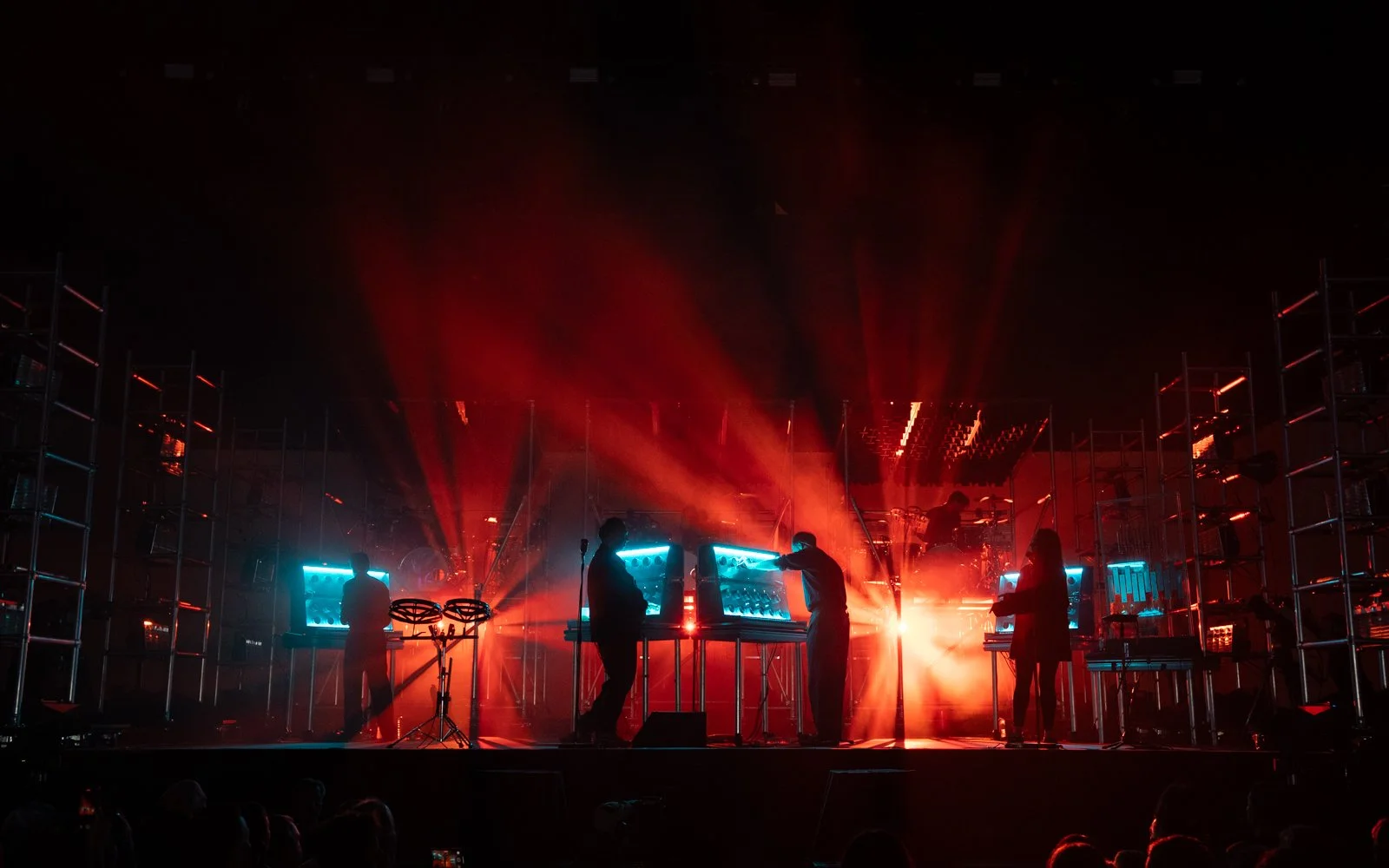 Live performance stage with elevated drum platforms and lighting