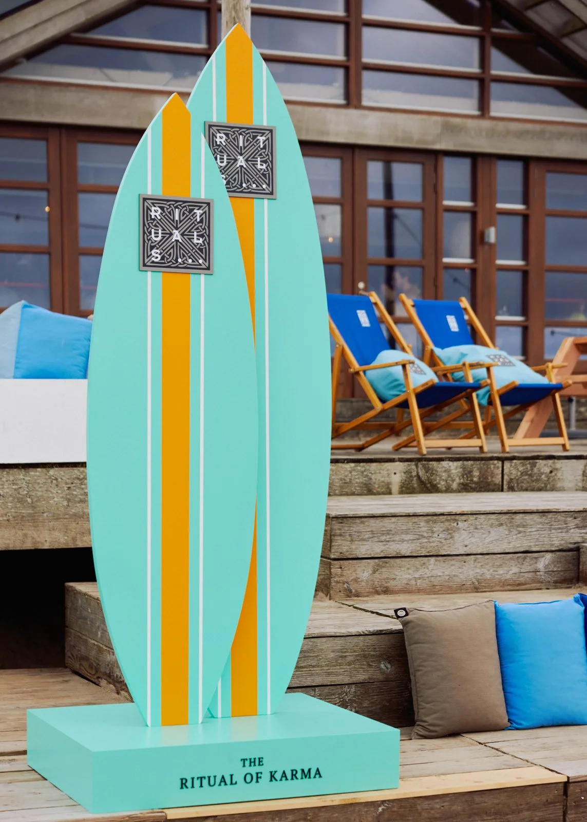 Beach pavilion transformation with custom loungers and surf-inspired scenography for Rituals Karma launch in Zandvoort