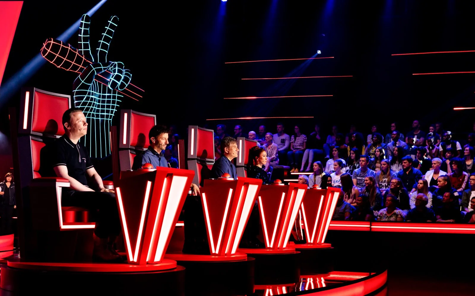 Engineered television set with reflective floor and dynamic lighting enhancing depth and camera readability