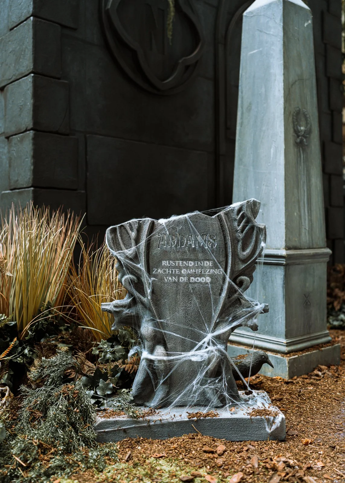 Gothic set design with trees gravestones and atmospheric lighting