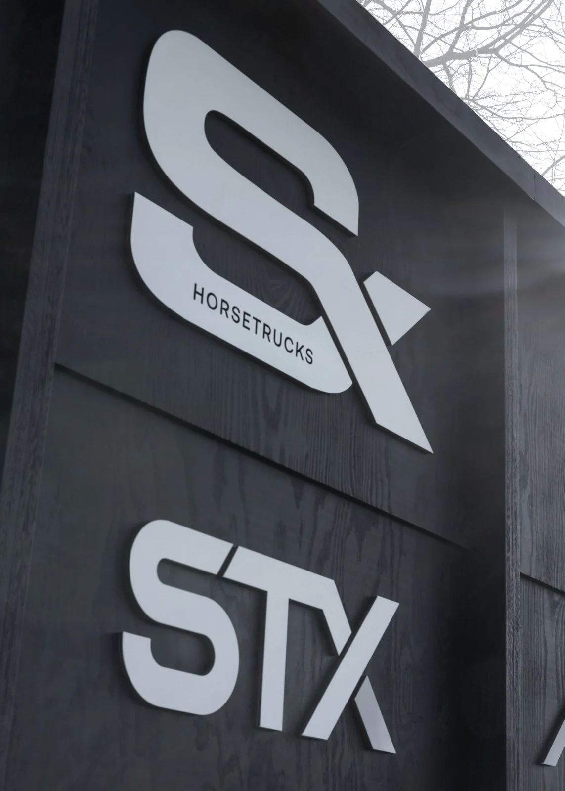 Custom-built stand inspired by equestrian architecture for indoor events