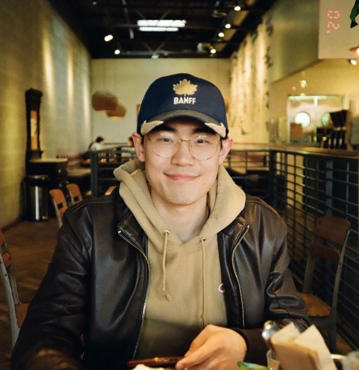 Stone Zhang wearing a casual outfit and smiling