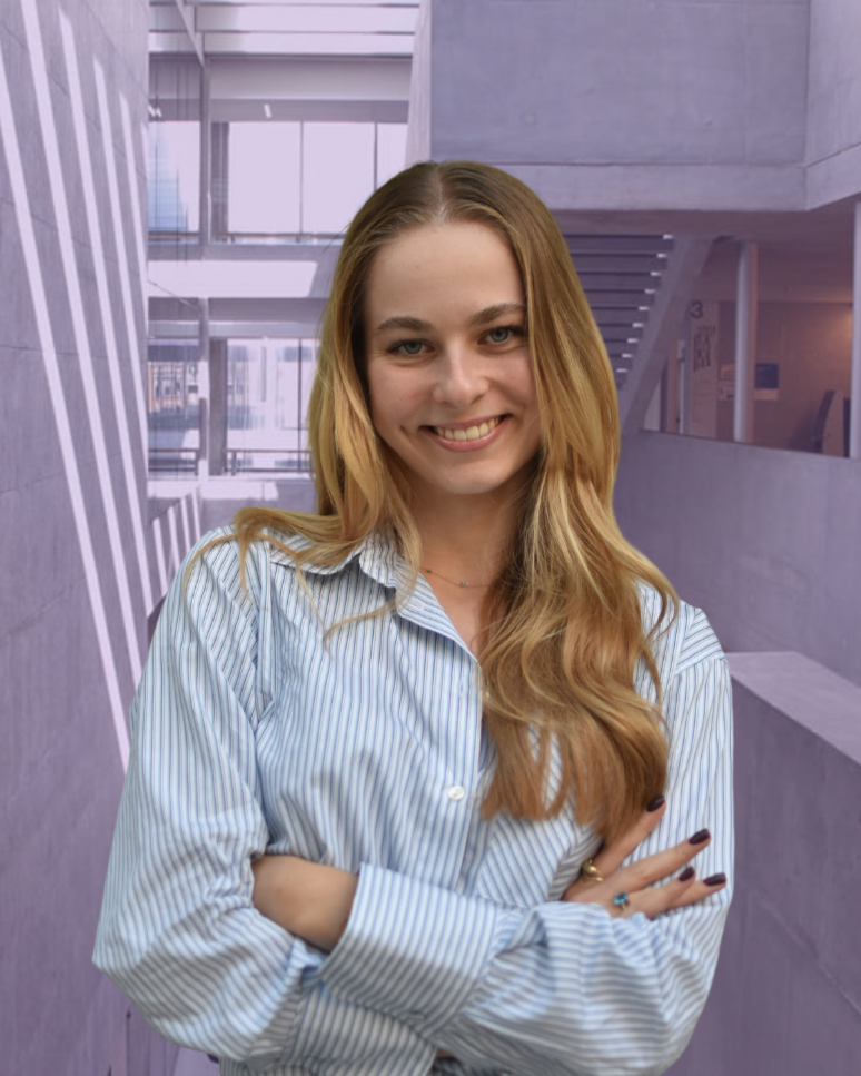 Confident woman with long hair and black blazer standing in front of a modern building with distinct columns, on a sunny day.
